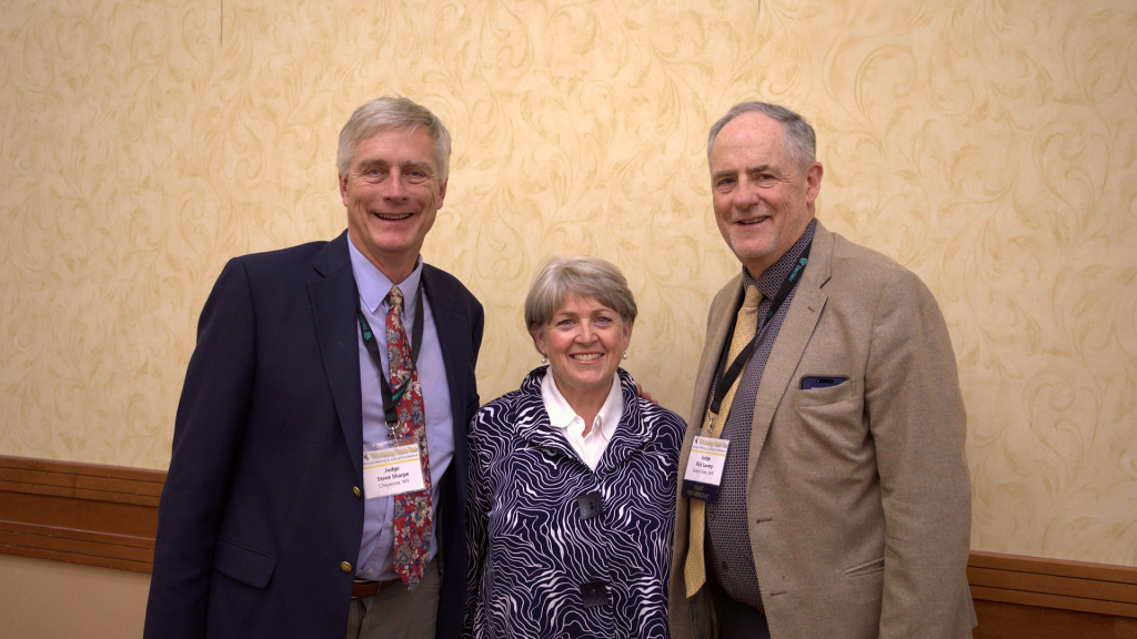 A woman in the middle, with two men on each side, smiling and looking forward. The woman is Chief Justice Lynne Boomgaarden, and the two men are Judges Steven Sharpe (Ret.) and Richard Lavery.